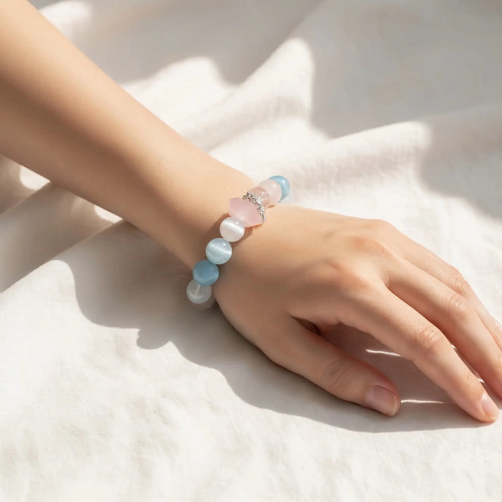 Dreamlight Harmony crystal bracelet with aquamarine and rose quartz beads on wrist