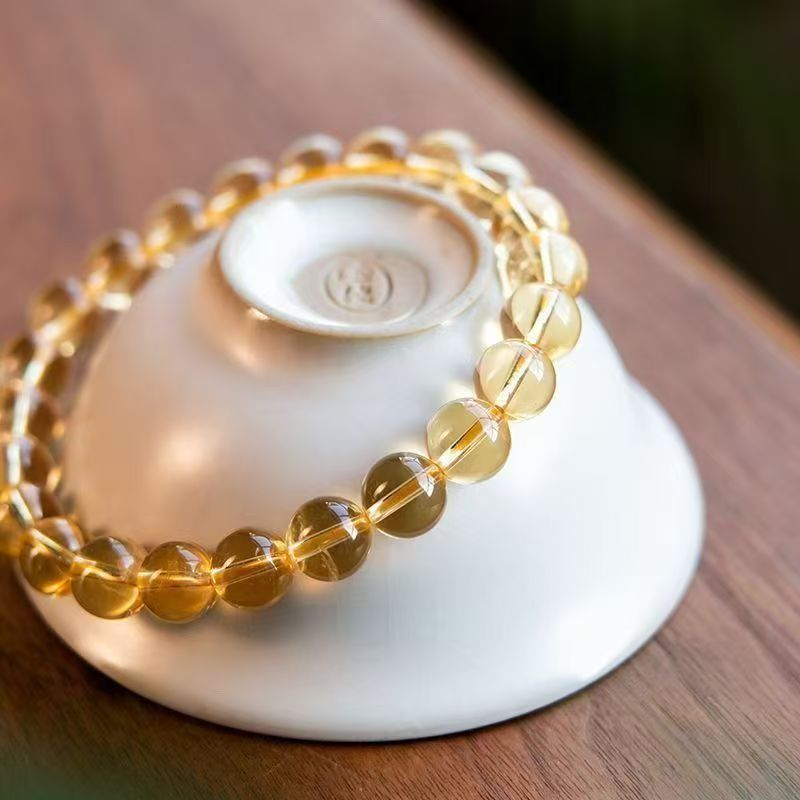natural-citrine-bead-bracelet-display-on-ceramic